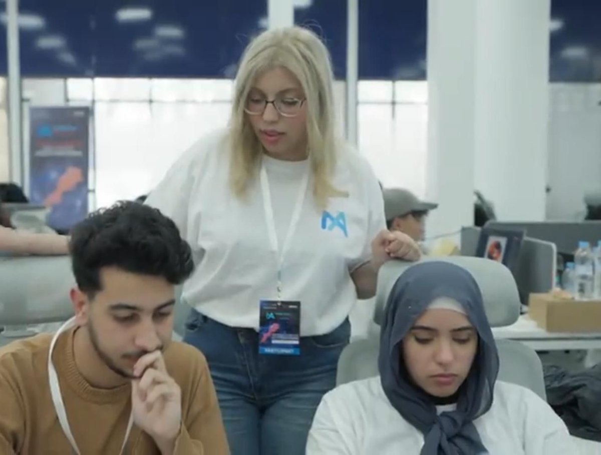 Nada working with teammates during the hackathon